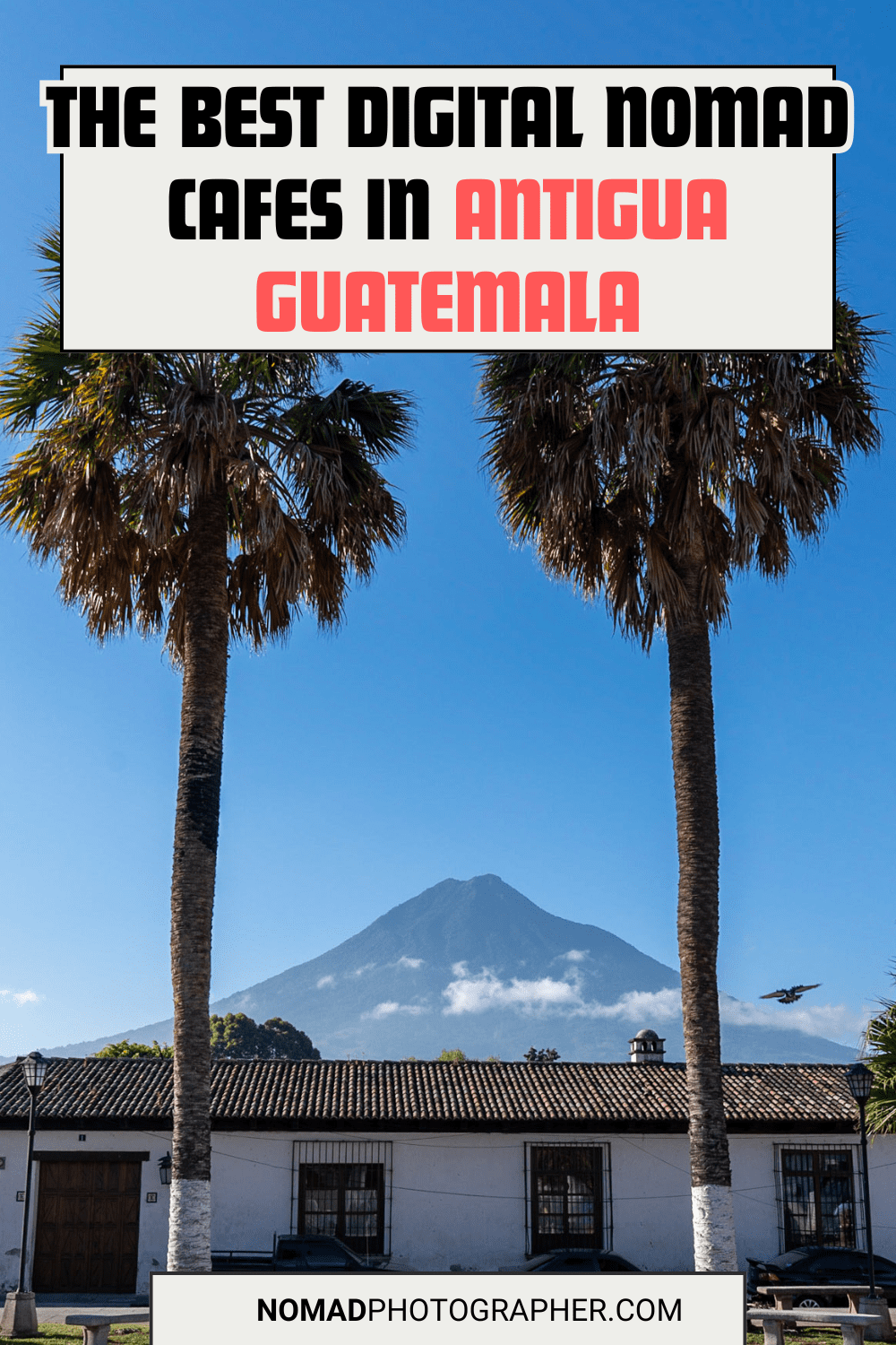 Colonial building in Antigua, Guatemala framed by palm trees. Volcán de Agua is visible in the background. Text promotes digital nomad cafes.