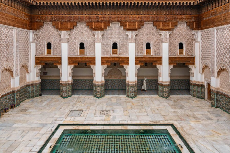 Devout Muslim walks through Mederssa Ben Youssef in Marrakech.